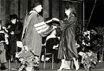 1981 CBR Commencement: Don Ross presents diploma to graduate by College of Boca Raton