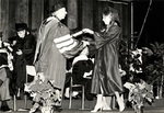1981 College of Boca Raton Commencement: Don Ross presents diploma to graduate by Lynn University