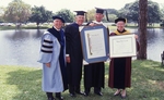 1992 Lynn Commencement: Ross, Mahoney and Osborne present honorary degree to Nathaniel Pryor Reed by Lynn University