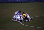 Men's Soccer Team Huddles on the Field by Brad Broome